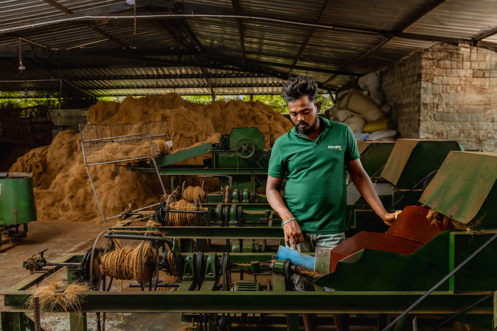 A Macgrow Lanka team member working at the coir processing mill